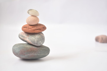 zen symbol, relaxing colorful stones with white background