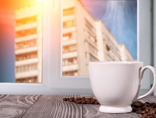 white cup with hot coffee on the table