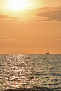 Golden Sunset at the Beach with Ship © LaDonna