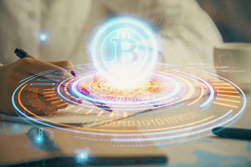 Obraz premium Cryptocurrency hologram over woman's hands writing background. Concept of blockchain. Double exposure