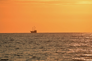 Golden Sunset at the Beach with Boat