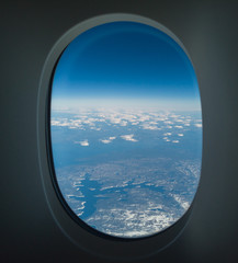 Flying over North America during spring season. Landscape from the airplane window. POV