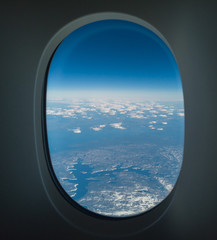Flying over North America during spring season. Landscape from the airplane window. POV