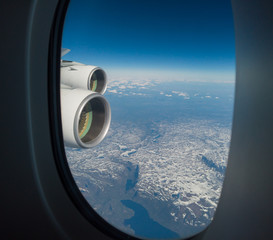 Fototapeta premium Flying over North America during spring season. Landscape from the airplane window. POV