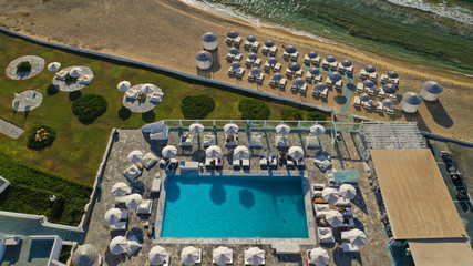 Aerial photo of famous sandy beach with turquoise clear sea of Megali Amos next to iconic and picturesque main town of Mykonos island, Cyclades, Greece