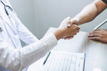 Doctor having shaking hands to congrats with patient after recommend treatment while discussing explaining his symptoms and counsel diagnosis health, healthcare and assistance concept