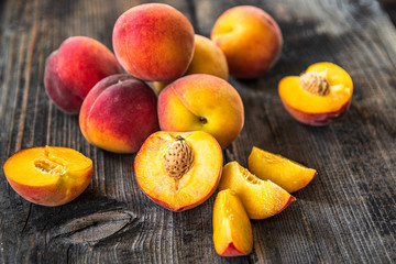 Fresh organic peaches on old wooden table