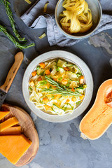 Butter squash pasta salad with zucchini slices, cheddar cheese and scallion