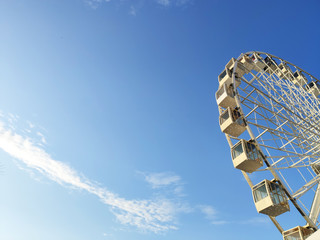  white ferris wheel amusement for entertainment against a blue sky