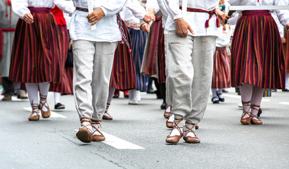 estonian people in traditional clothing walking the streets of Tallinn