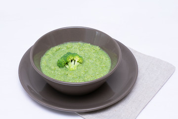 Vegetarian soup of broccoli puree on a white background. The concept of healthy eating.