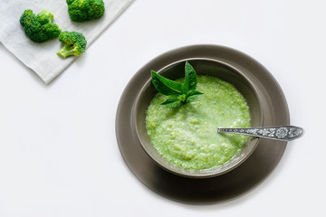 Vegetarian soup of broccoli puree on a white background. The concept of healthy eating.