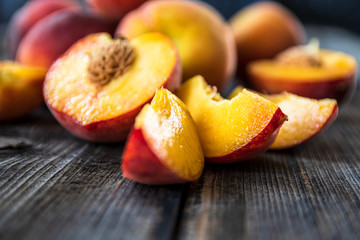 Fresh organic peaches on old wooden table