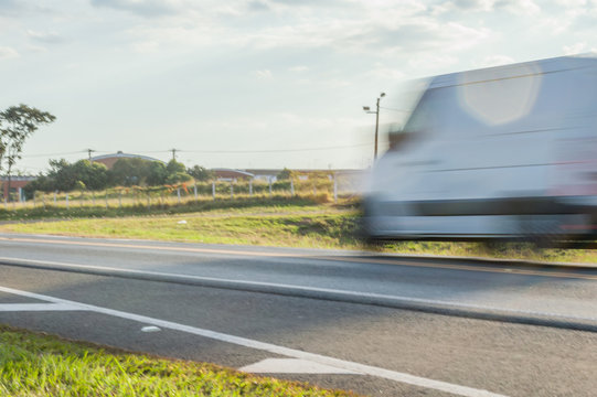 blur - photo of a moving van at high speed on the highway