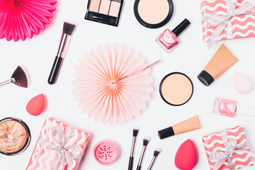 Pink flat lay background of makeup products