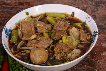 Thai style soup with meat and mushrooms