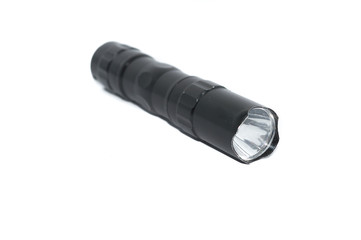 small black flashlight tactical for camping and hiking trails isolated on white background