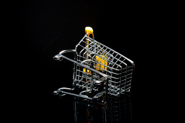 Fototapeta na wymiar Close-up of shopping carts on black background.Trolley, Sale concept.Empty grocery shopping cart. Isolated over black background.