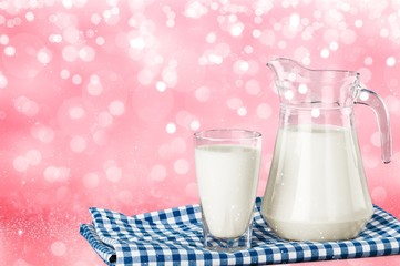 Glass of milk and bottle on  background