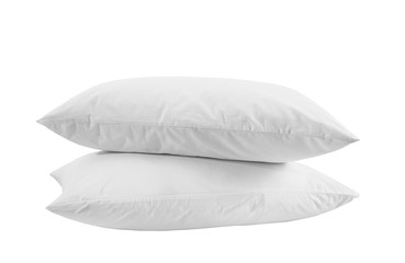 Two white pillows isolated, pillows on a white background, two pillows piled against white background. Side view.