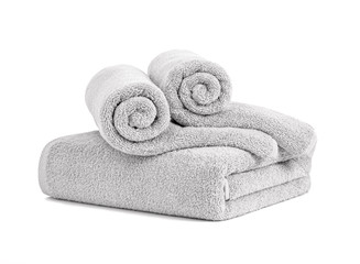 Obraz na płótnie Canvas Gray terry towels rolled, folded and stacked isolated.Terry towels against white backdrop. Folded and rolled soft bath towels. Stack of grey cotton towels on a white background front view
