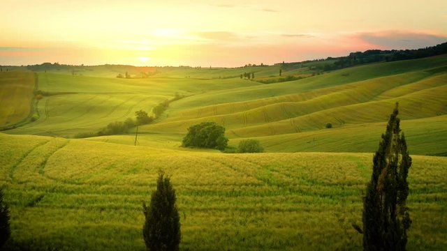 Flying over the amazing rolling hills of Tuscany Italy at sunset