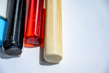Assorted bar stock of translucent and opaque supplies for glass blowing