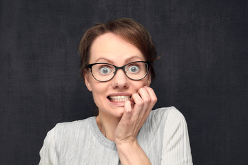 Portrait of shocked young woman with glasses