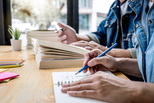 High school tutor or college student group sitting at desk in library studying and reading, doing homework and lesson practice preparing exam to entrance, education, teaching, learning concept