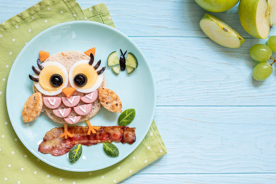 Naklejki Fun food for kids - cute little owl sandwich toast with sausages and eggs