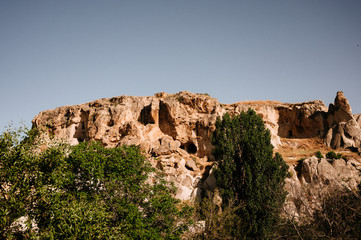 Fototapeta premium Rocks looking like mushrooms dramatically lit by a sunset in Cappadocia, Turkey