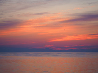Naklejka na ściany i meble Dawn over the sea. The sun rises over the Mediterranean