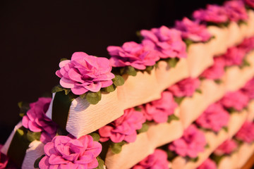 sweets happily married on black background, stacked sweets, lined up sweets, well married, well married wrapped in crepe paper, white packaging for candy