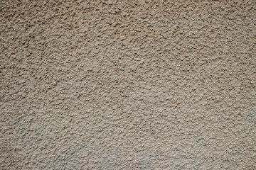 Beige painted stone pebble wall texture