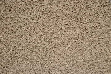 Beige painted stone pebble wall texture