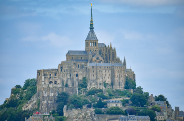 Fototapeta na wymiar Close-up of Mont Saint Michel, France, in a blue cloudy sky.