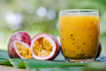 Close-up passion fruit juice and half-passion fruit on the table the concept of healthy food.