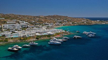Aerial panoramic photo of famous turquoise clear sea celebrity sandy beach and bay of Psarou with...