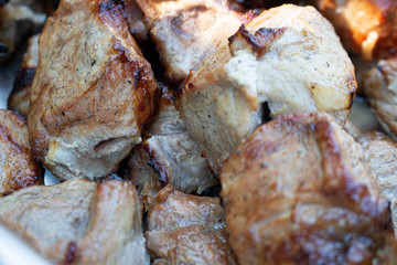 pieces of fried meat lie on a plate close-up