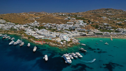 Aerial panoramic photo of famous turquoise clear sea celebrity sandy beach and bay of Psarou with...