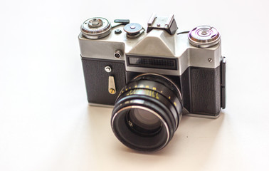 Vintage camera on white background. Old retro camera, closeup photo of old camera lens. Concept for the photographer, old photographic equipment, minimalistic style.