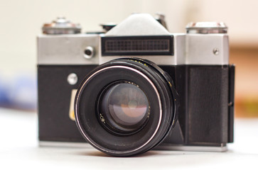 Vintage camera on white background. Old retro camera, closeup photo of old camera lens. Concept for the photographer, old photographic equipment, minimalistic style selective focus