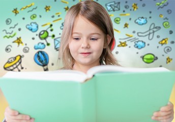 Adorable young girl reading a book