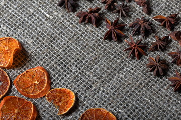 Dried orange and anise slices for decoration. Laid out on a rough linen fabric