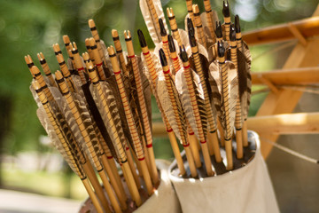 Many handcrafted arrows in a brown leather quiver full with arrows in crafted in medieval style,...