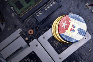 golden bitcoins with flag of cuba on a computer electronic circuit board. bitcoin mining concept.