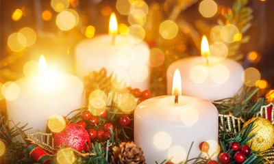 Candles light. Christmas candles burning at night. Abstract candles background. Golden light of...