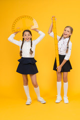 Formula. back to school. Maths and geometry. Kids in uniform at yellow wall. friendship and...