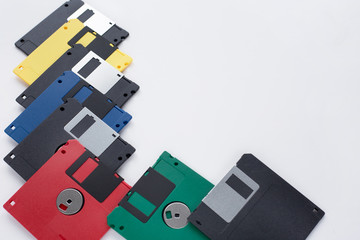 Group of multi-colored flexible disks isolated on a white background. Retro technology.