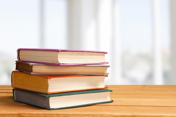 Colorful books collection on background.